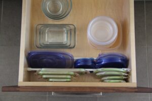 Use tension rods to hold lids in place